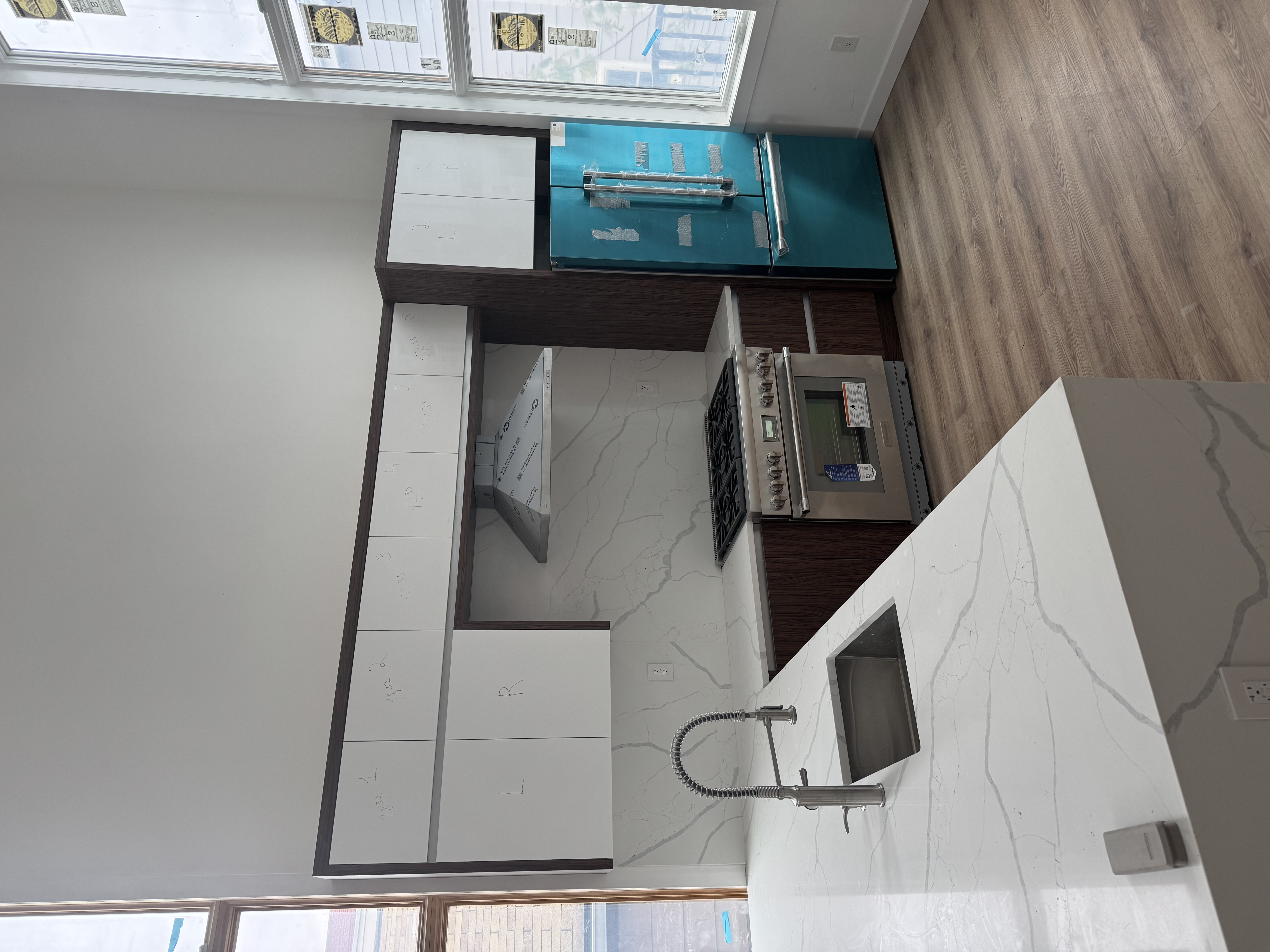2811 Brown Street Brooklyn, NY 11235 - Photo 1 of 3 a kitchen with kitchen island granite countertop a sink cabinets and wooden floor