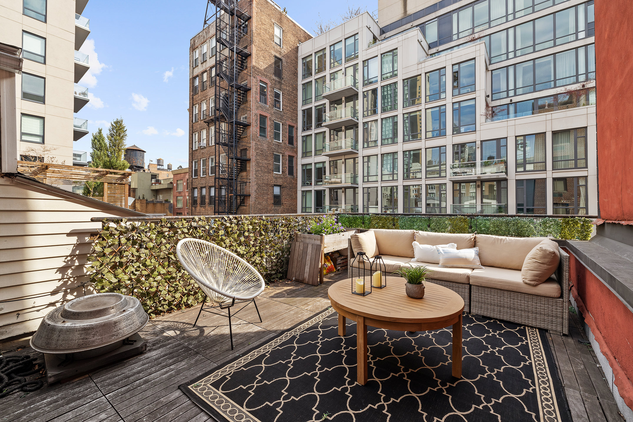 136-140 West 23rd Street, Unit PHD Manhattan, NY 10011 - Photo 2 of 15 a balcony with couches and a potted plant