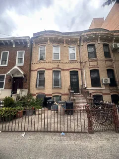 a front view of a house with a fence