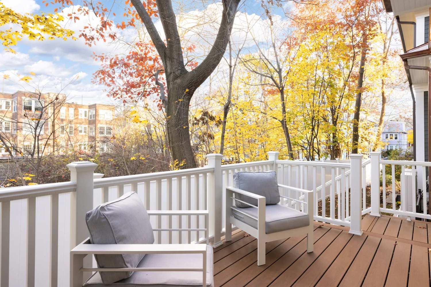 a view of deck with couches and wooden fence