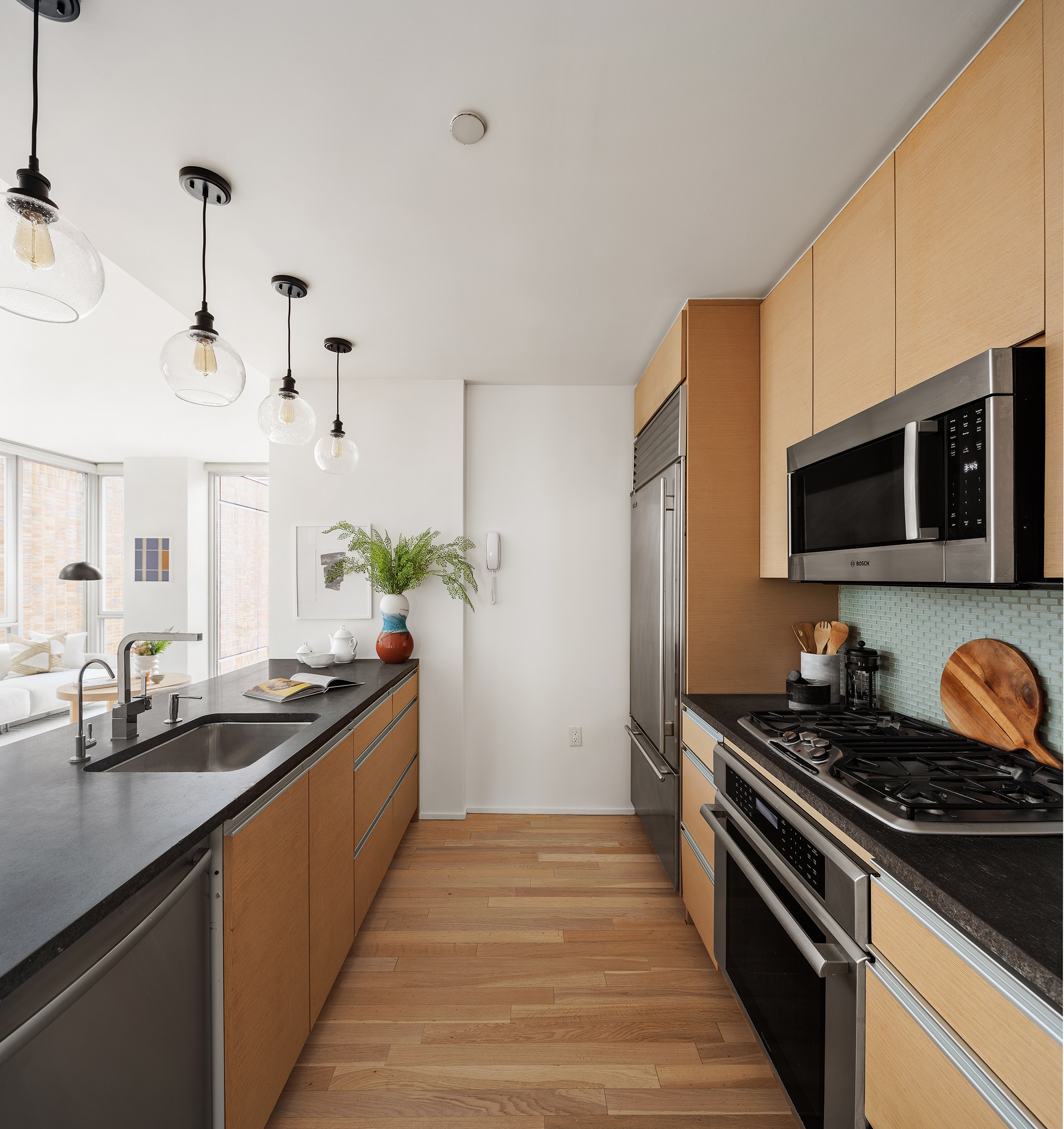 110 3rd Avenue, Unit 4B Manhattan, NY 10003 - Photo 4 of 15 a kitchen with stainless steel appliances a sink stove and microwave