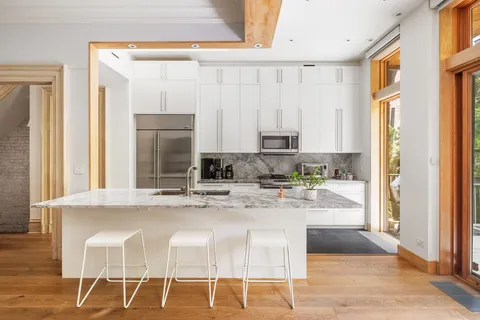 a kitchen with stainless steel appliances granite countertop a sink and a window