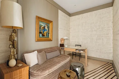 a living room with furniture and a lamp