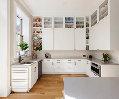 a kitchen with a sink stove and cabinets