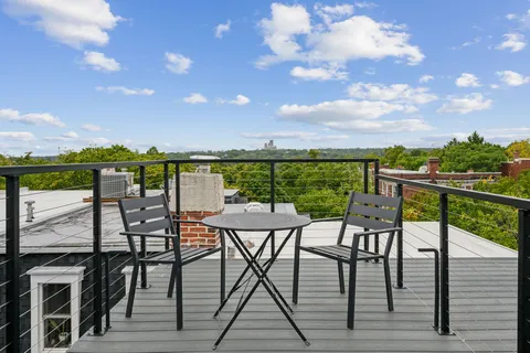 a view of a balcony with furniture