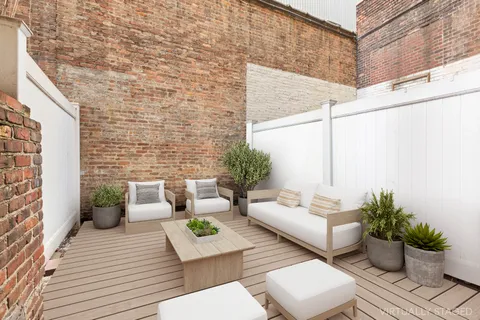 a view of a patio with couches and potted plants