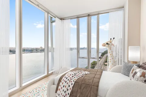 a bedroom with a large bed and a chandelier