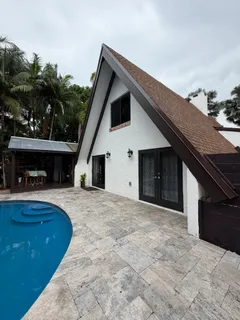 a view of house and garden with sitting area