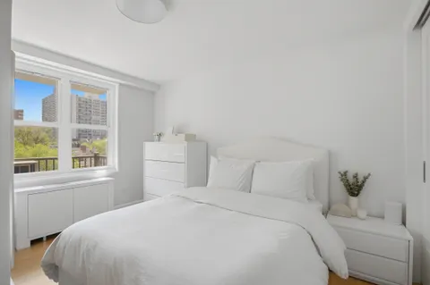 a bedroom with a bed and a window with outer view