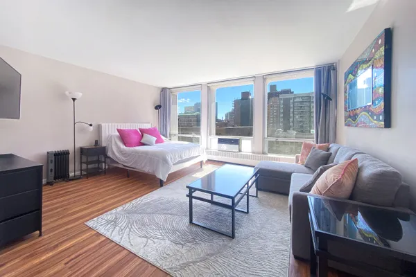 a living room with furniture and a wooden floor