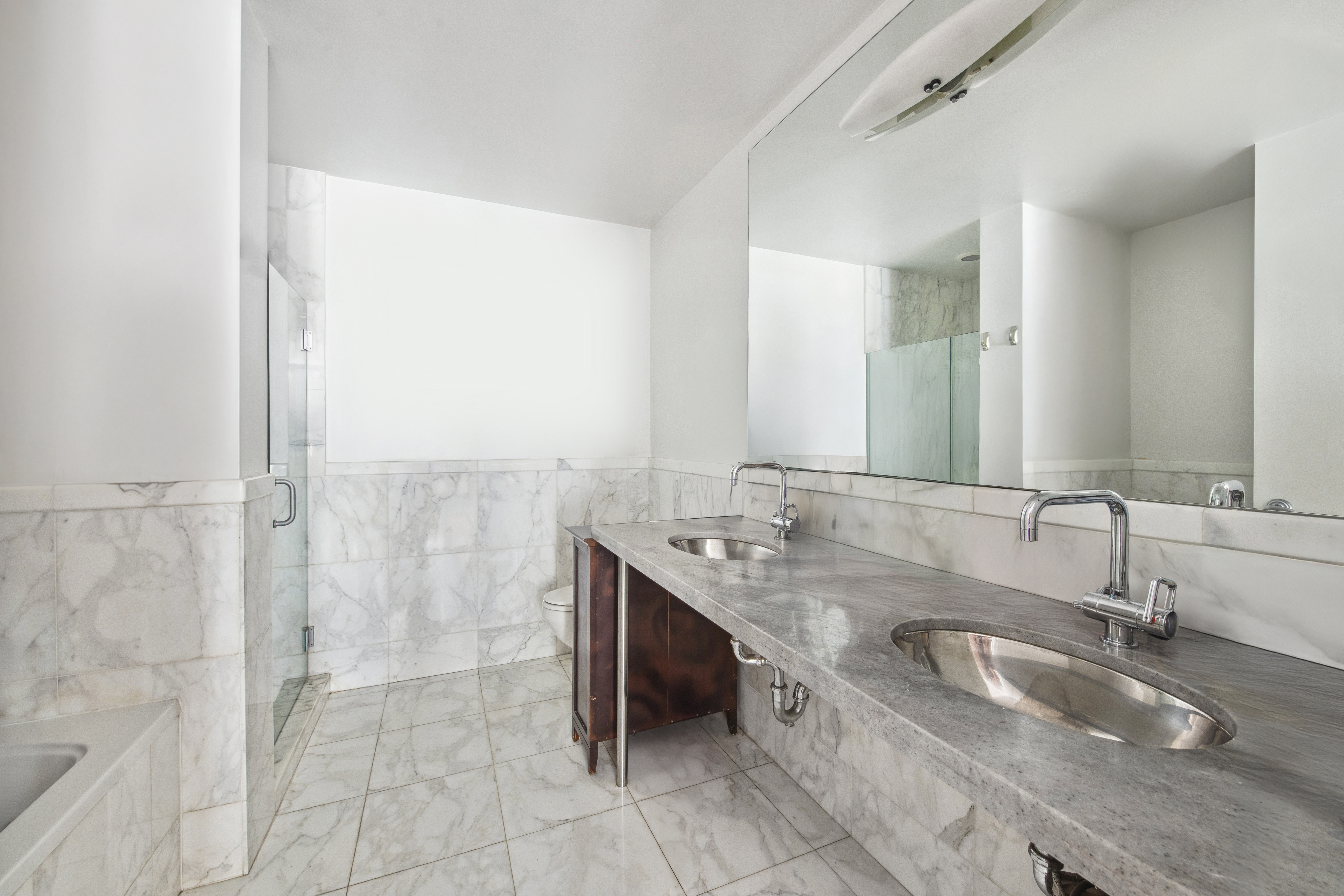 151 West 17th Street, Unit 5A Manhattan, NY 10011 - Photo 7 of 11 a bathroom with a granite countertop sink and a mirror