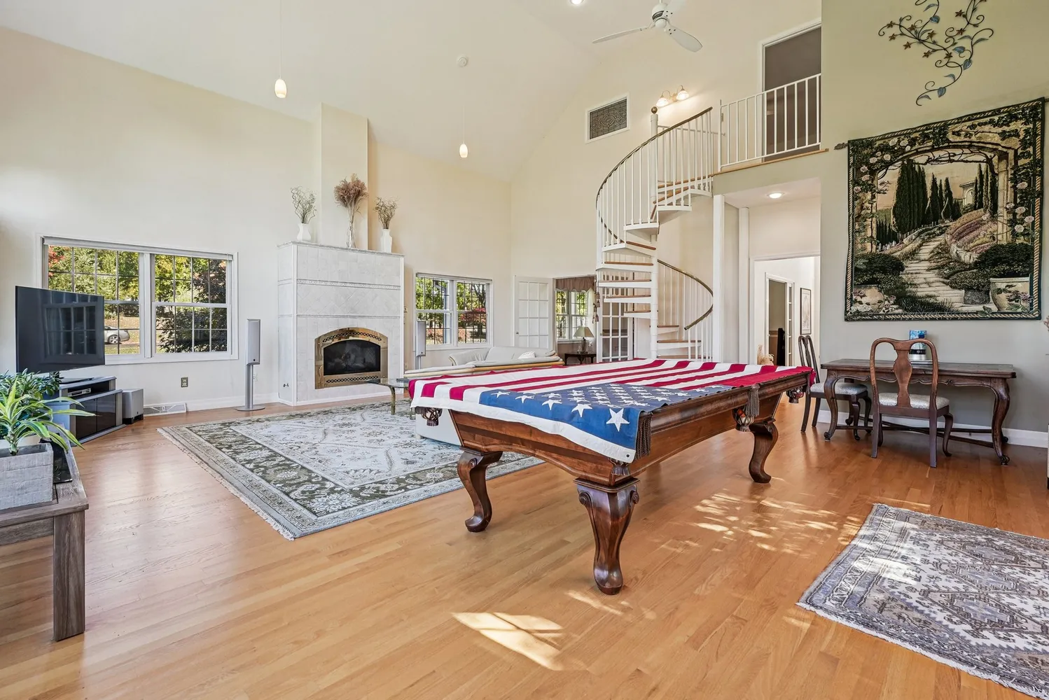 a living room with furniture pool table and a fireplace