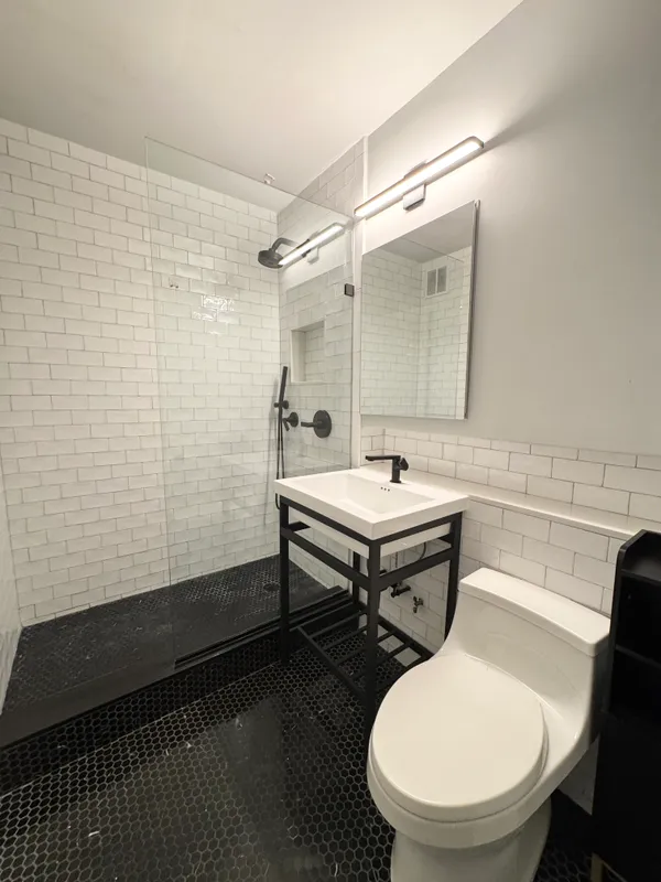 a bathroom with a sink mirror and toilet