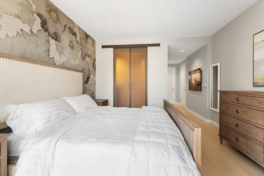 a bedroom with a bed and a dresser