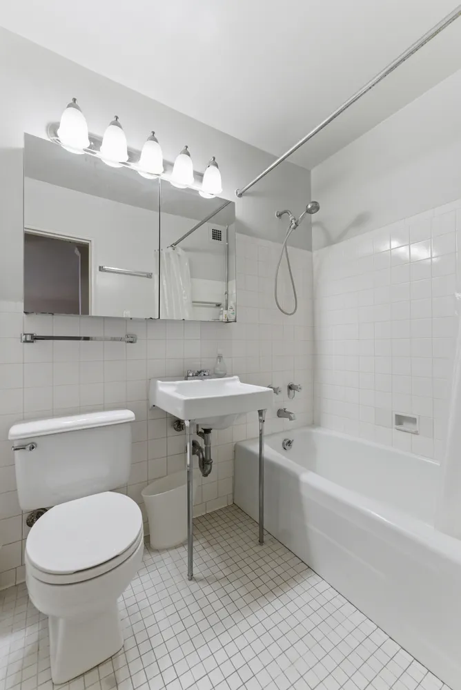 a bathroom with a sink a toilet and bathtub