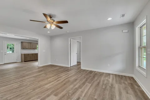 wooden floor in an empty room with a window