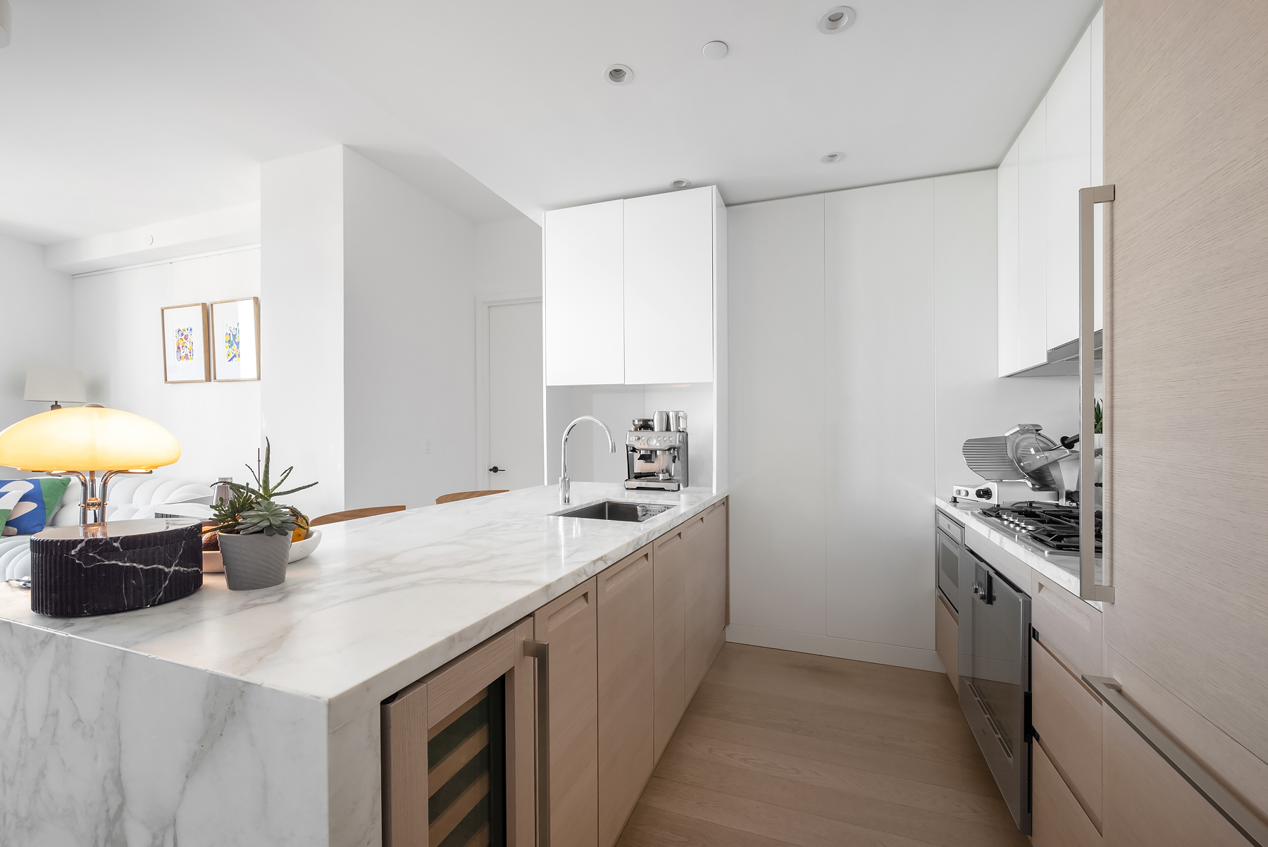 30 Riverside Boulevard, Unit 32E Manhattan, NY 10069 - Photo 4 of 19 a kitchen with stainless steel appliances a sink a stove and a refrigerator