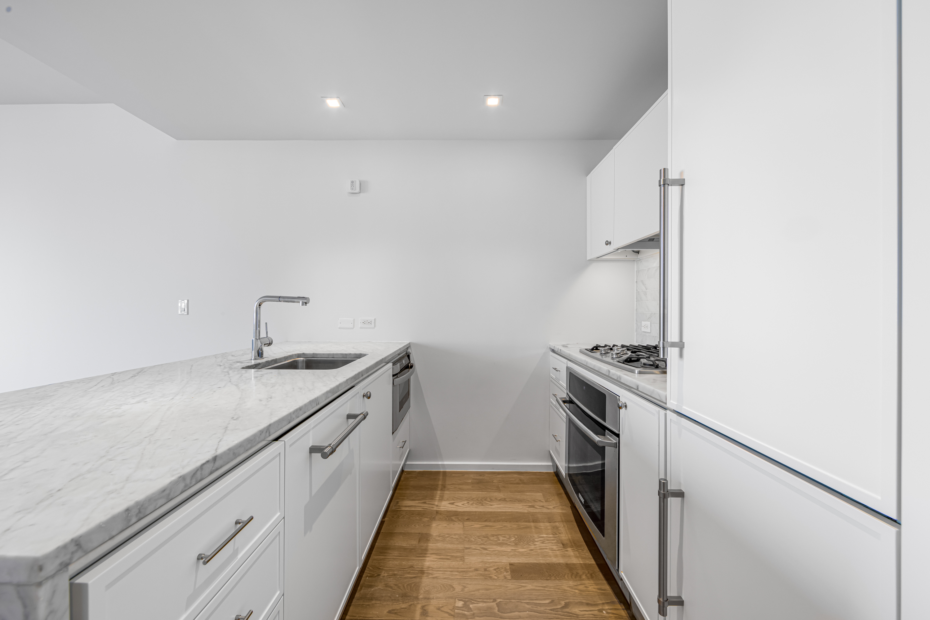 202 8th Street, Unit 4E Brooklyn, NY 11215 - Photo 3 of 19 a kitchen with granite countertop sink stainless steel appliances and cabinets