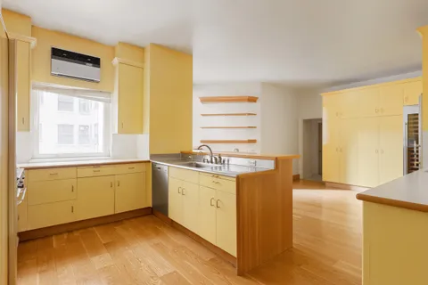 a kitchen with granite countertop a sink and a stove top oven