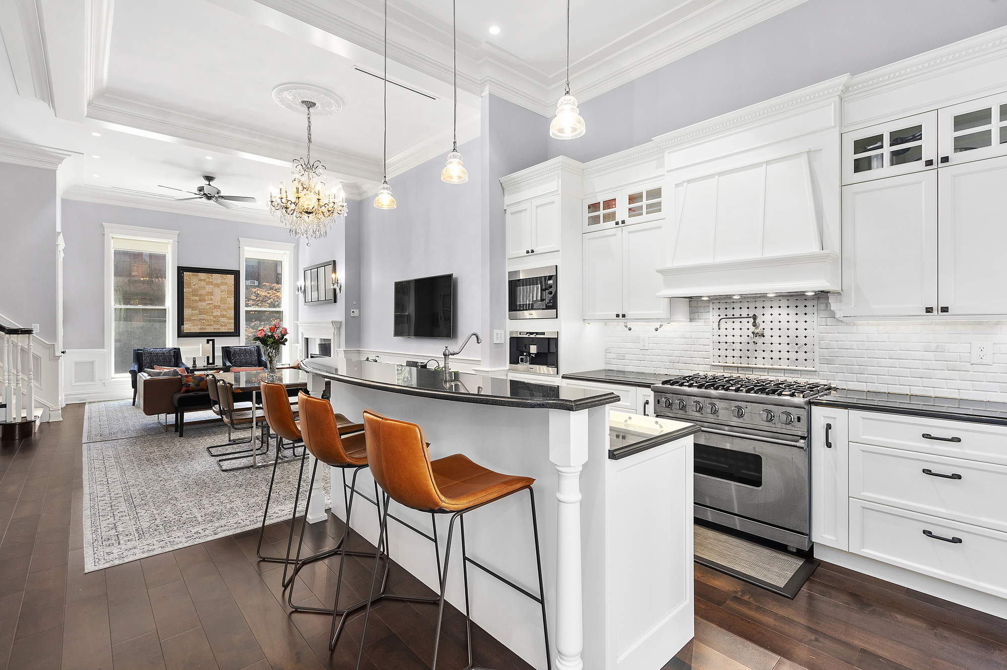 67 Greene Avenue, Unit 2 Brooklyn, NY 11238 - Photo 2 of 15 a kitchen with stainless steel appliances granite countertop a stove top oven a sink dishwasher a dining table and chairs with wooden floor