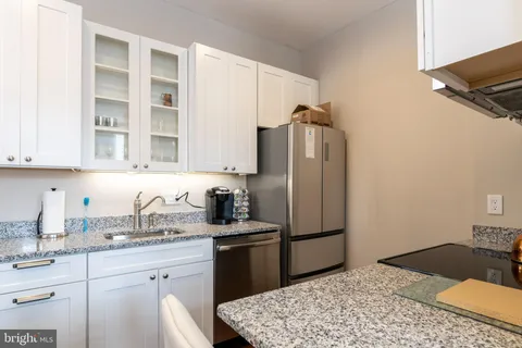 a kitchen with a sink appliances and cabinets