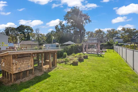 a front view of a house with a yard fountain and a fire pit