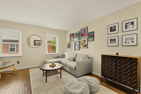 a living room with furniture a rug and a window