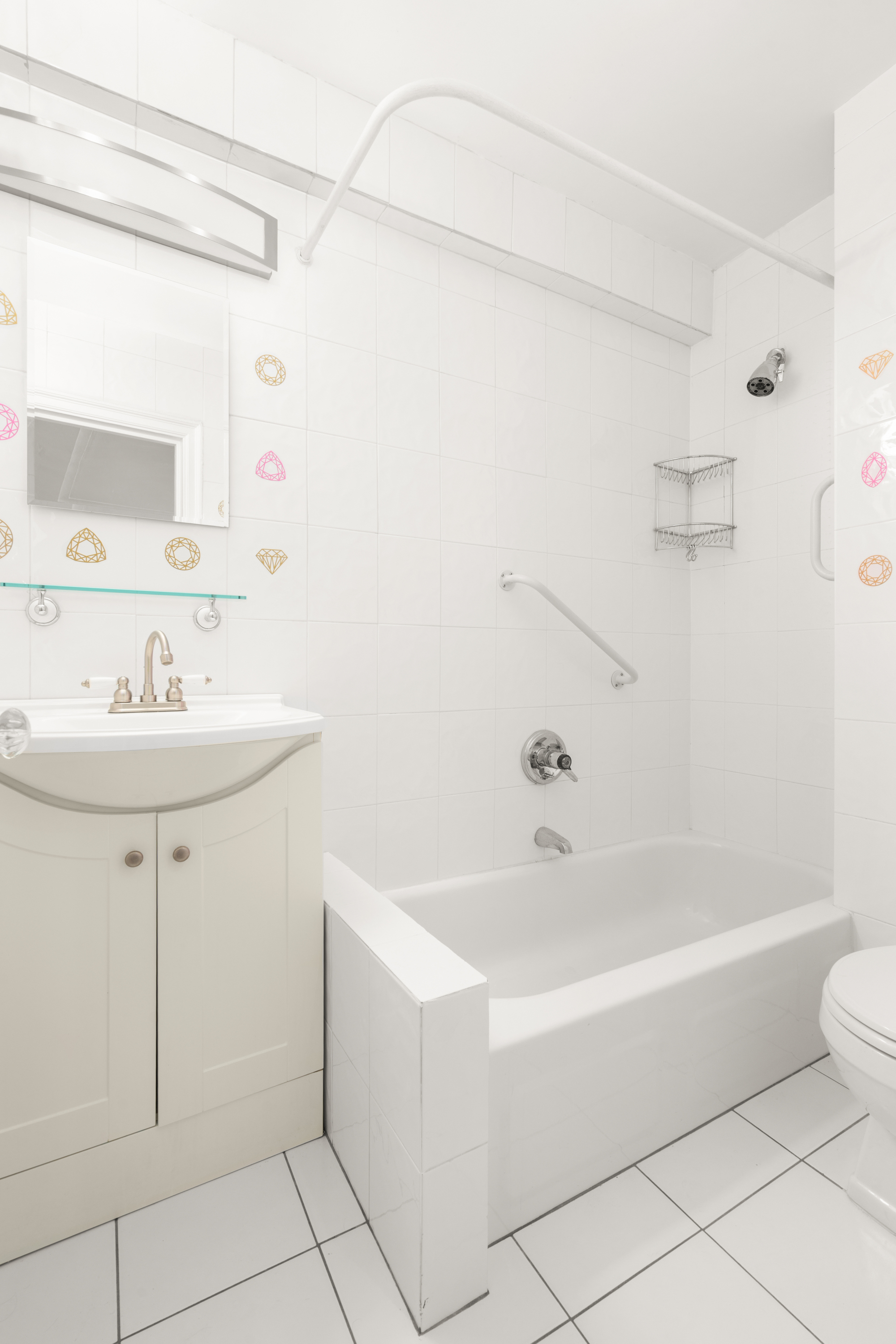 227 East 57th Street, Unit 3DEF Manhattan, NY 10022 - Photo 5 of 13 a bathroom with a sink a toilet and shower