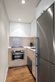 a kitchen with a refrigerator and a stove top oven