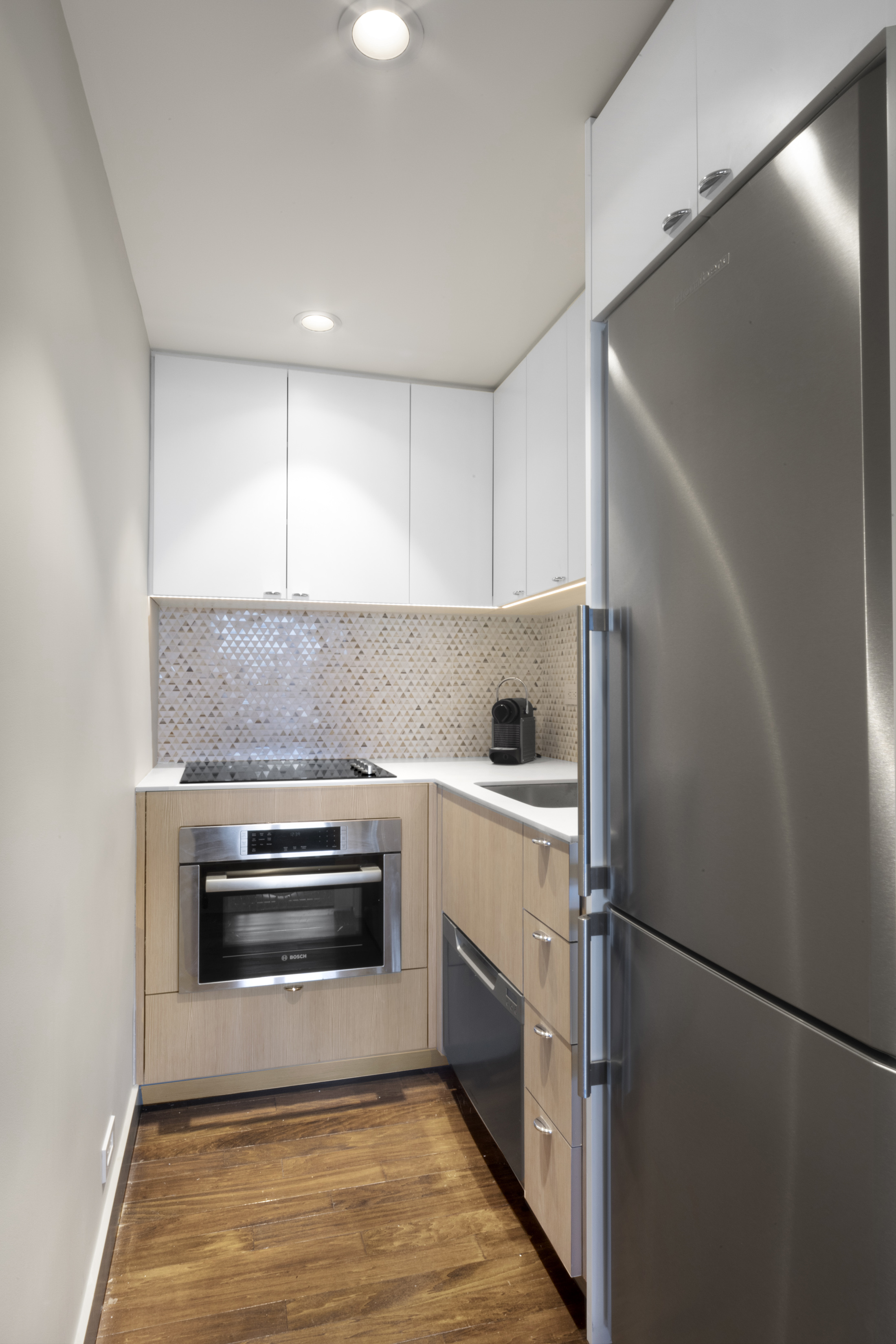 160 Central Park South, Unit 3903 Manhattan, NY 10019 - Photo 3 of 11 a kitchen with a refrigerator and a stove top oven