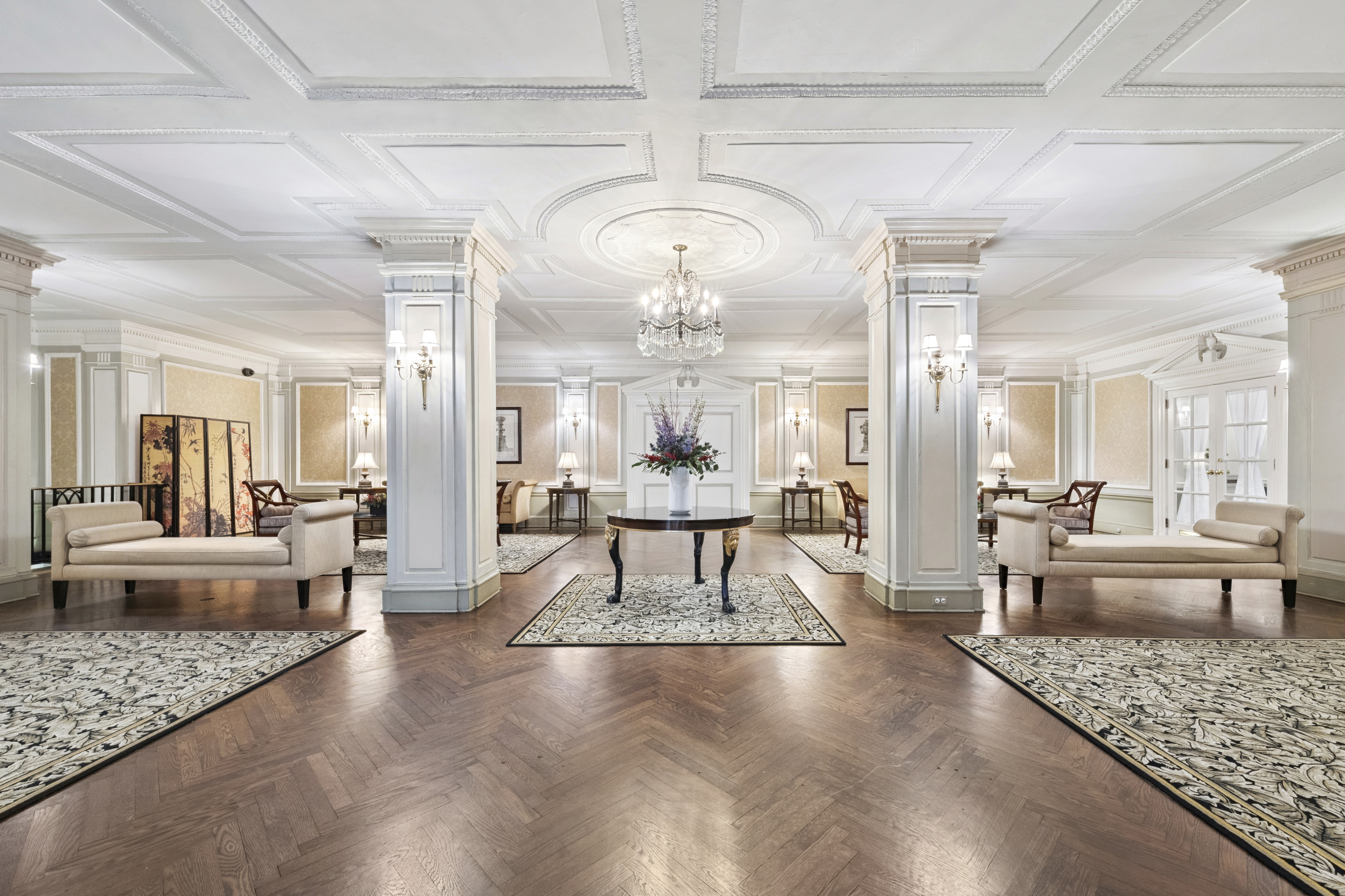 225 Central Park West, Unit 916 Manhattan, NY 10024 - Photo 7 of 13 a living room with furniture and a chandelier