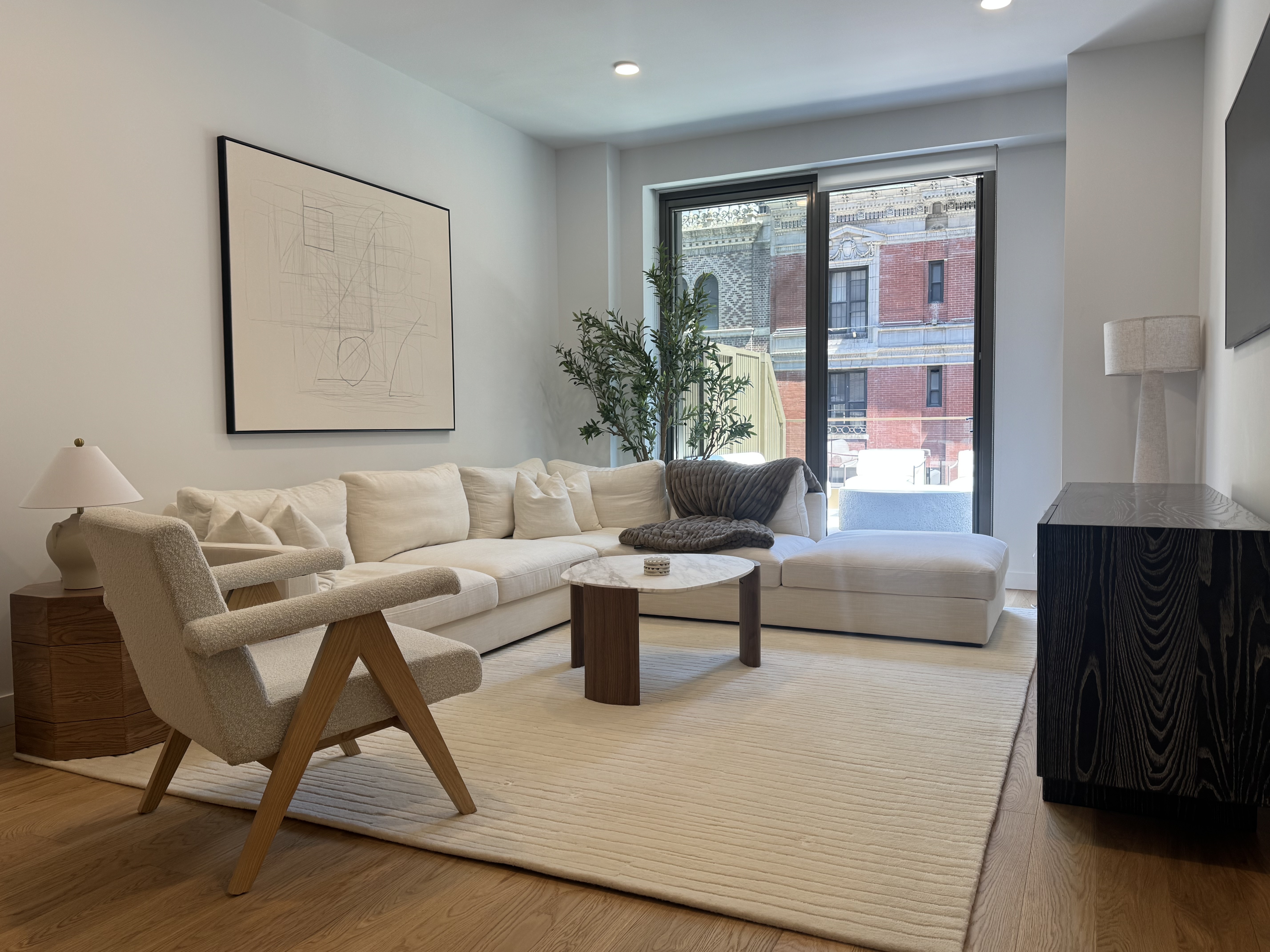 18 West 55th Street, Unit 7B Manhattan, NY 10019 - Photo 5 of 20 a living room with furniture and a window