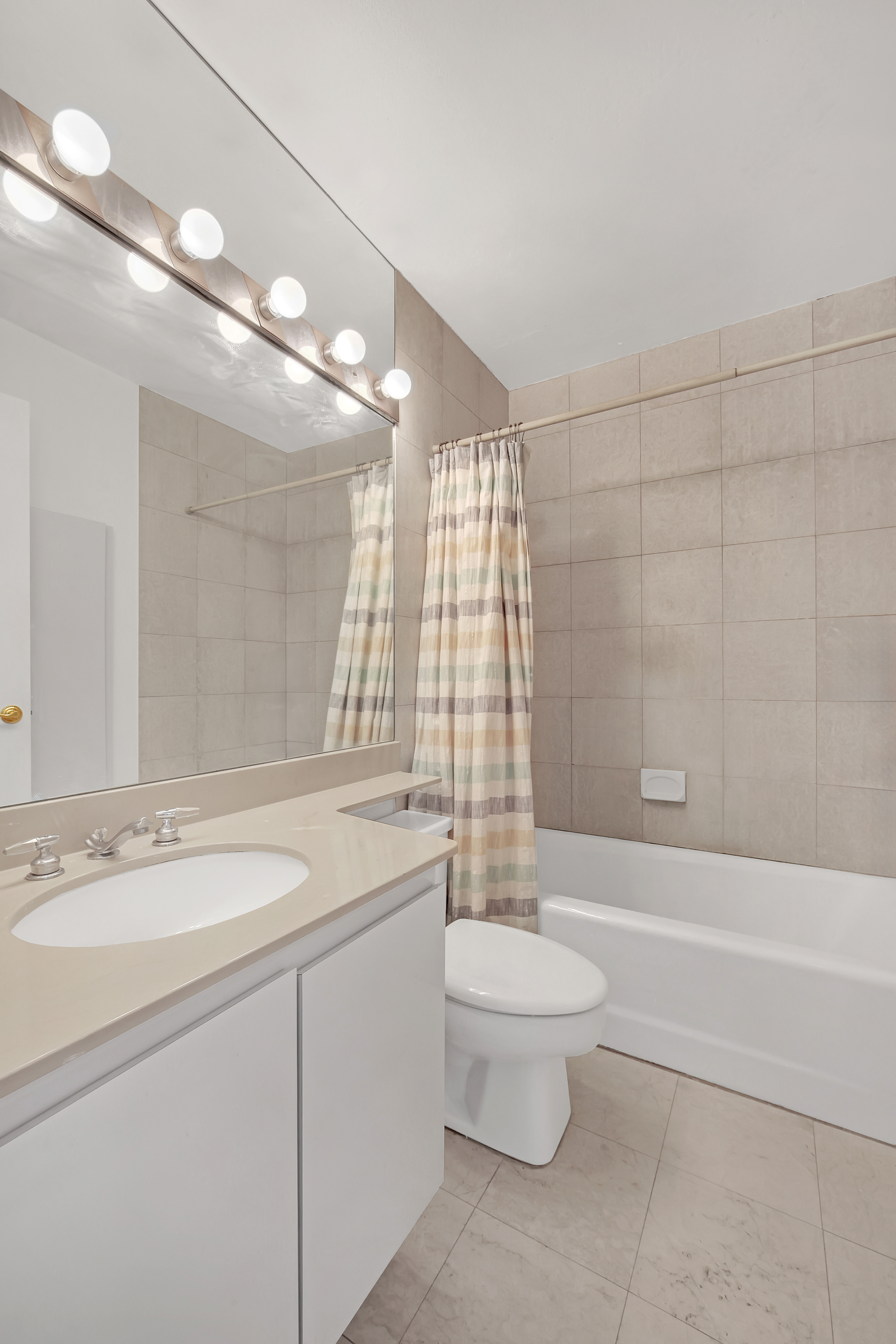 330 East 75th Street, Unit 8H Manhattan, NY 10021 - Photo 6 of 11 a bathroom with a sink a toilet and shower