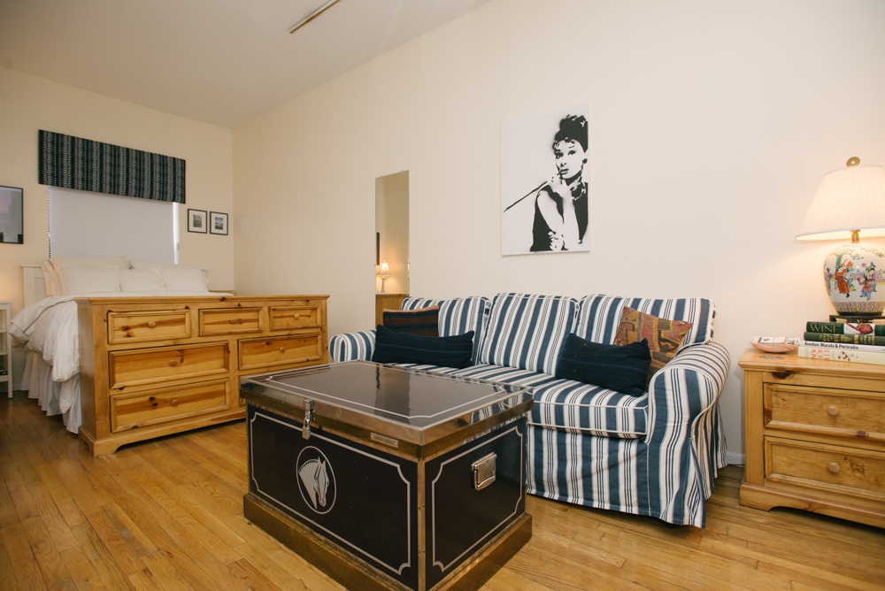 126 East 83rd Street, Unit 2C Manhattan, NY 10028 - Photo 1 of 5 a living room with a bed and dresser