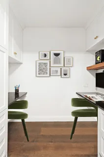 a room with furniture and paintings on the wall