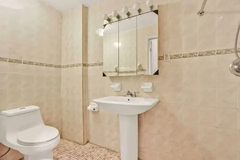 a kitchen with stainless steel appliances granite countertop a refrigerator a stove and a sink