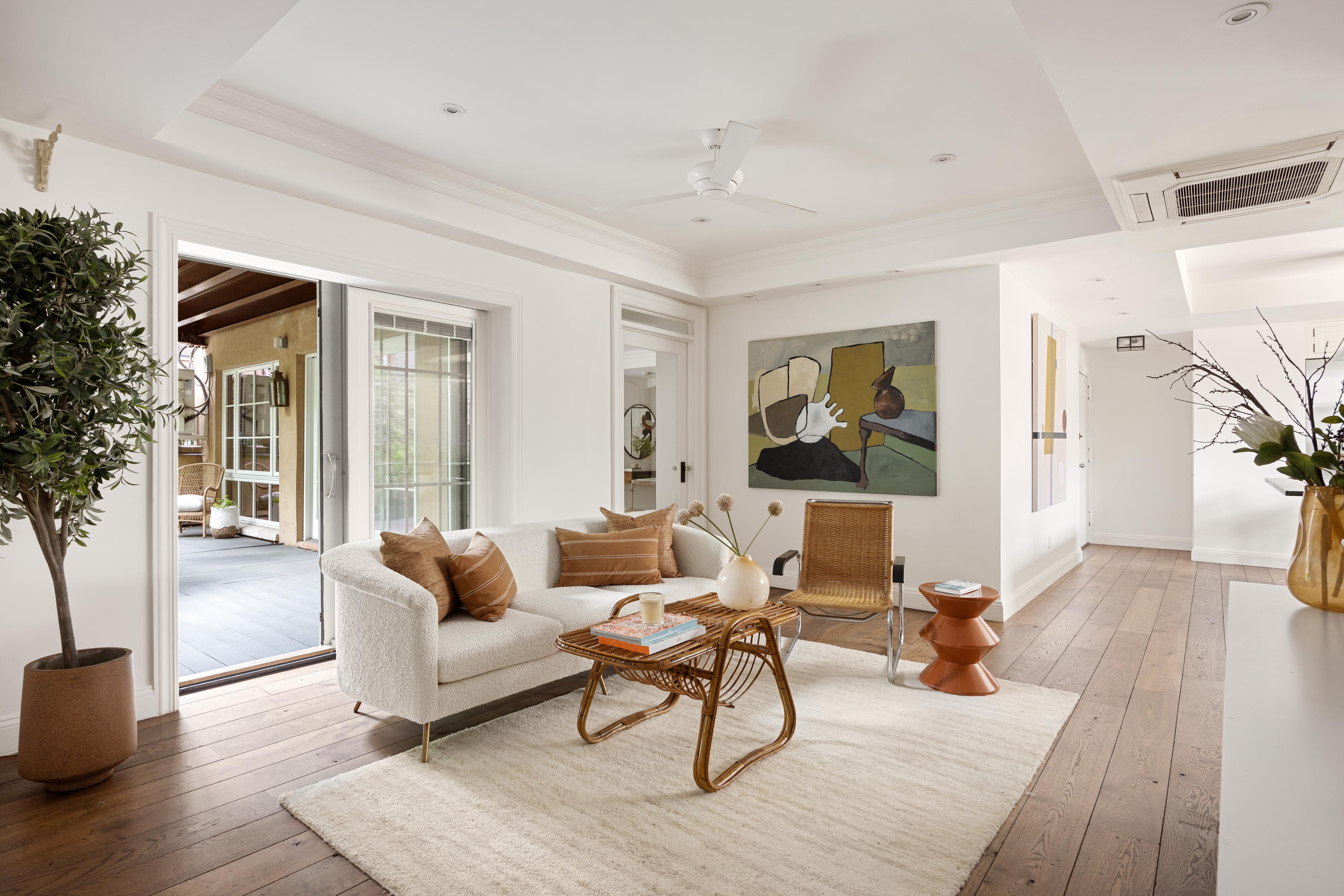 50 Avenue A, Unit 2AB Manhattan, NY 10009 - Photo 1 of 12 a living room with furniture and a wooden floor
