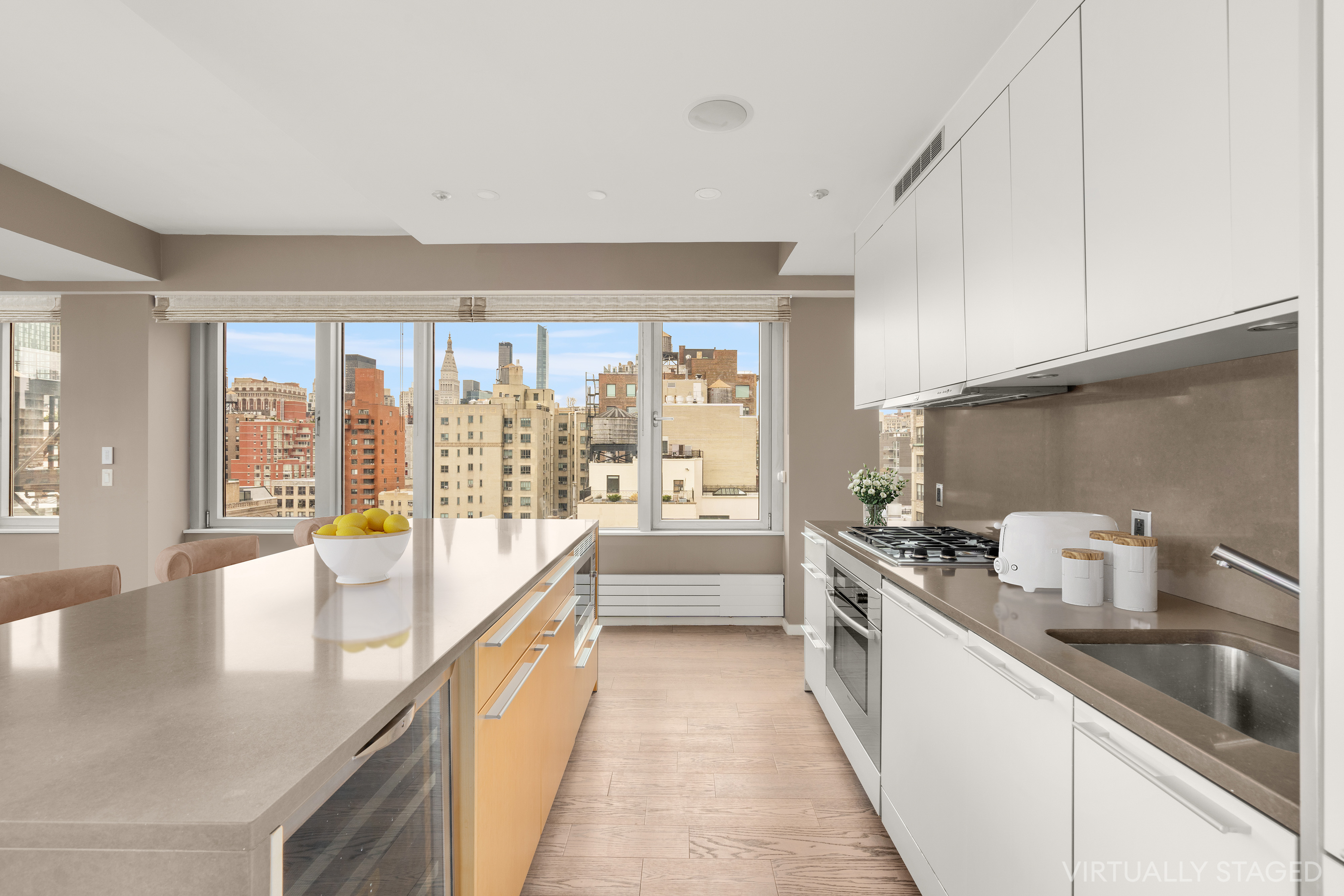 245 West 19th Street, Unit PH4 Manhattan, NY 10011 - Photo 6 of 13 a large white kitchen with a large window