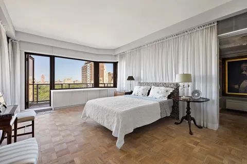 a bedroom with a large bed and a large window