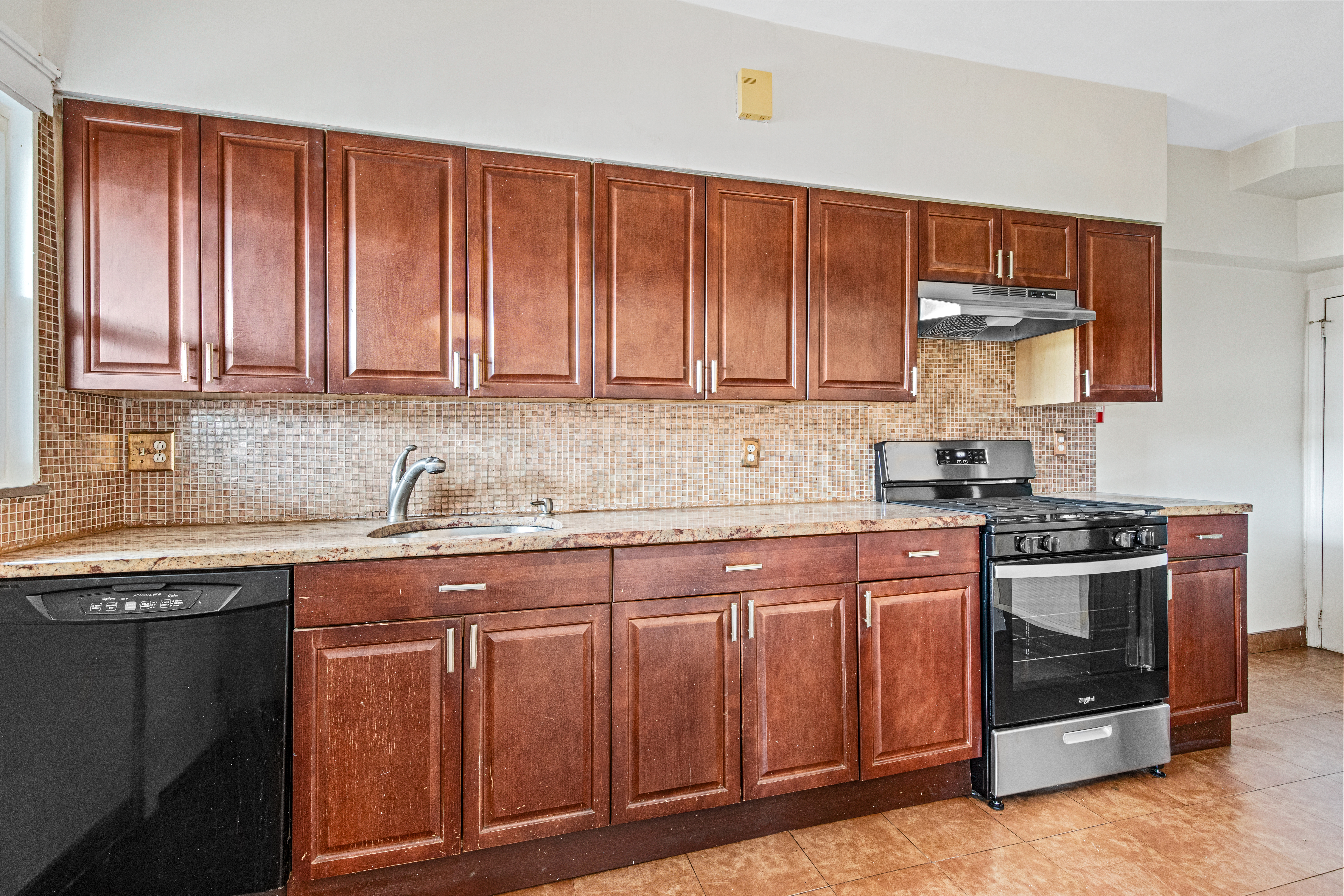 32 Tudor Terrace Brooklyn, NY 11224 - Photo 6 of 15 a kitchen with stainless steel appliances granite countertop a stove sink and cabinets