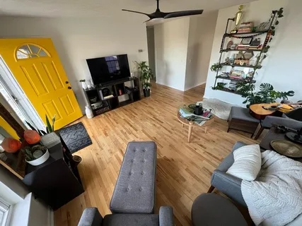 a living room with furniture and a flat screen tv