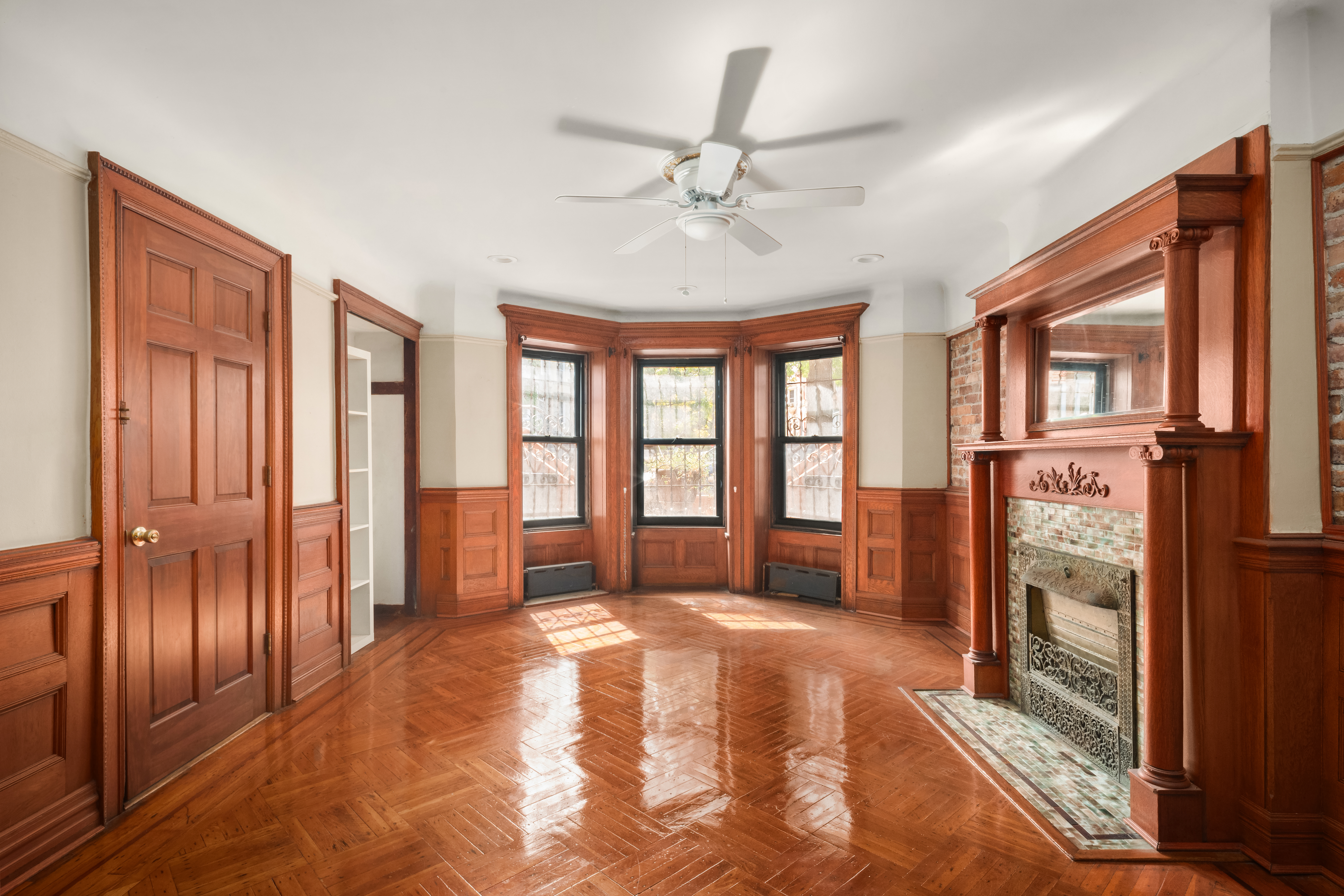 1135 Park Place Brooklyn, NY 11213 - Photo 13 of 18 a spacious bedroom with a large bed and a chandelier