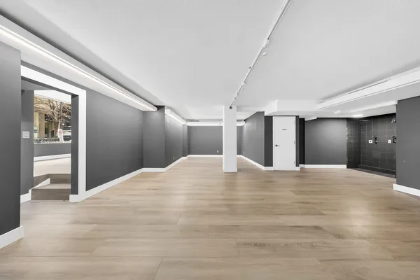 a view of a livingroom with wooden floor and a window