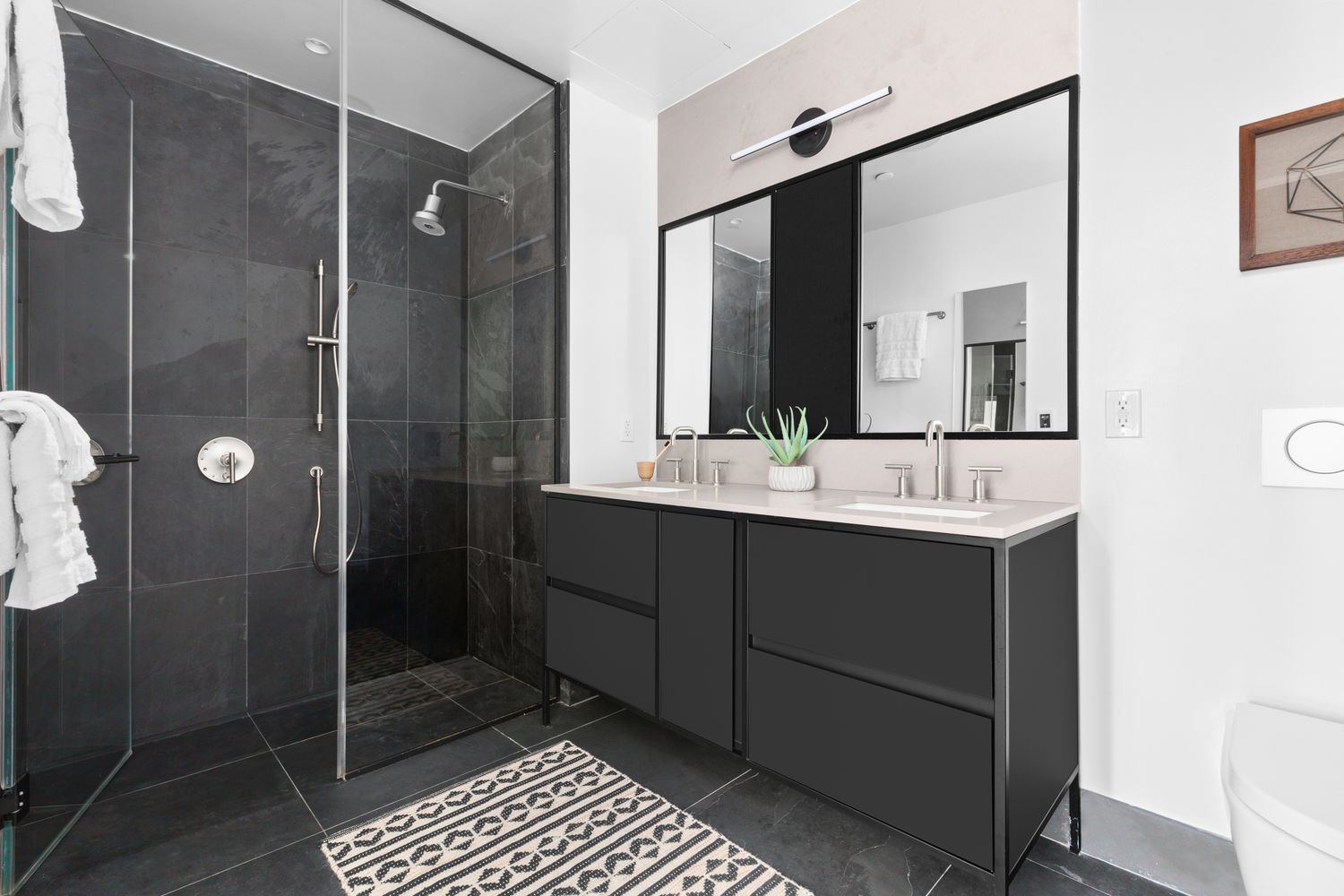 a bathroom with a double vanity sink mirror and shower