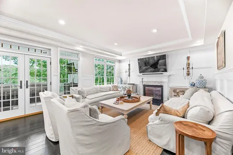 a view of a dining room and livingroom with lots of furniture wooden floor and a large window