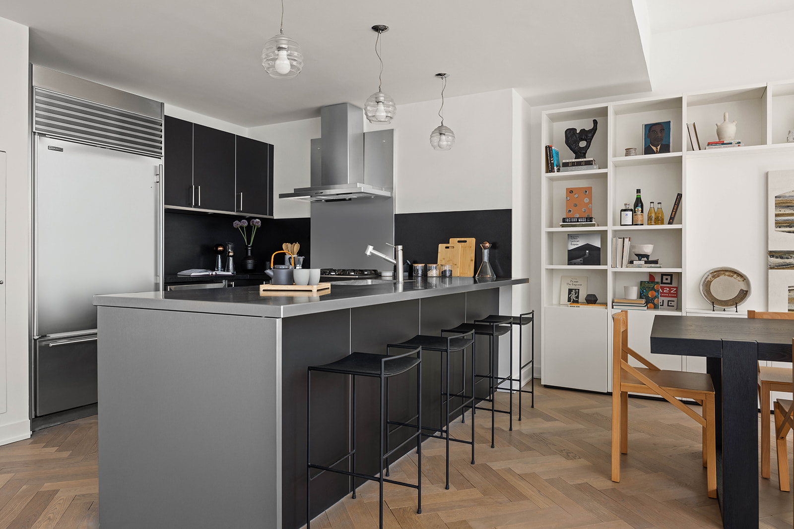 330 Spring Street, Unit 7D Manhattan, NY 10013 - Photo 4 of 11 a kitchen with a table chairs refrigerator and cabinets