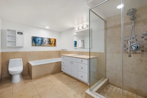 a bathroom with a tub sink toilet and a shower