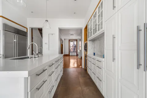 a bathroom with double vanity and mirrors