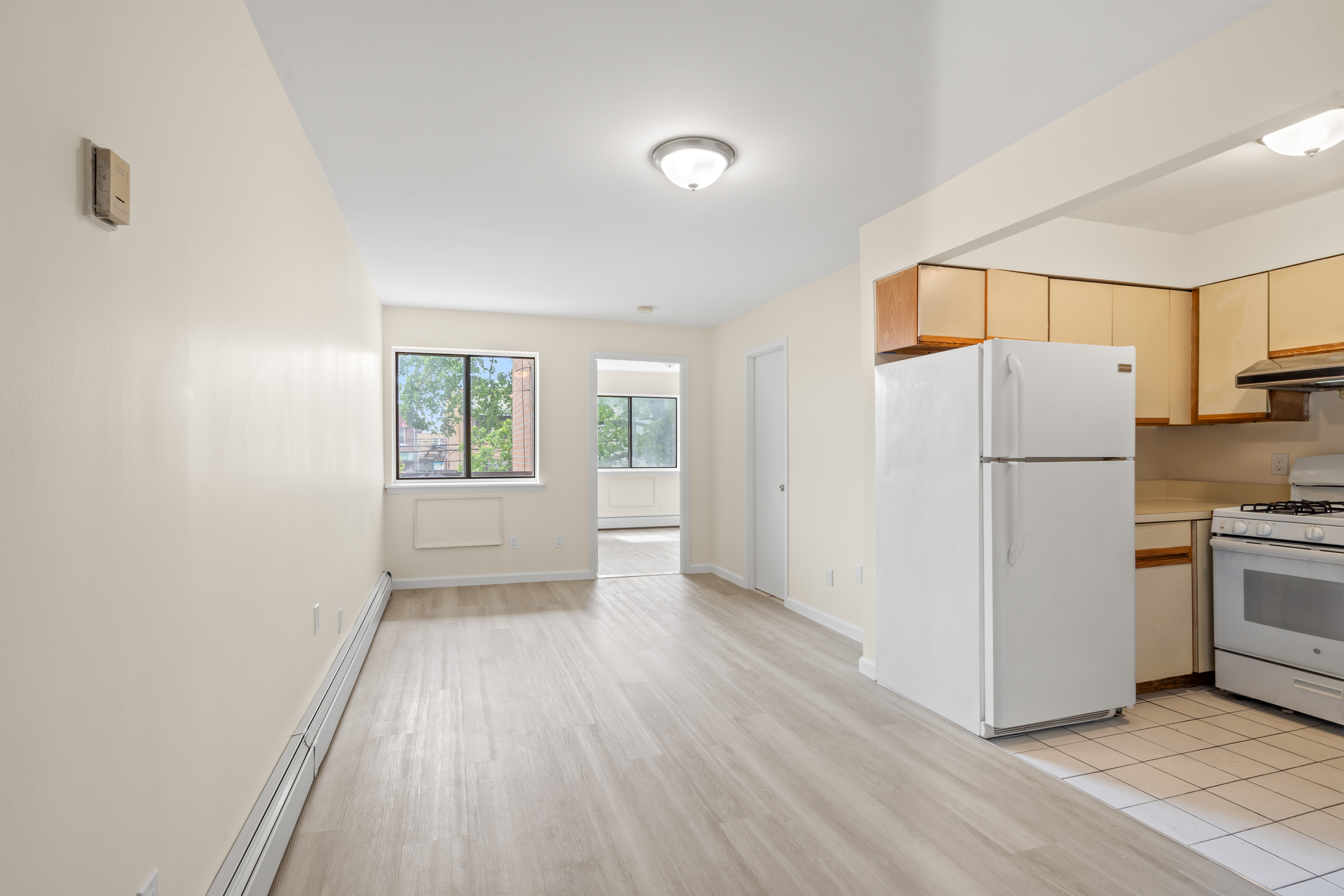 a view of a kitchen with a refrigerator a stove top oven and a refrigerator
