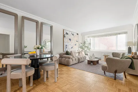 a living room with furniture and large windows